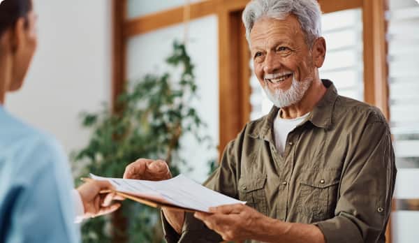 Smiling man providing his intake papers