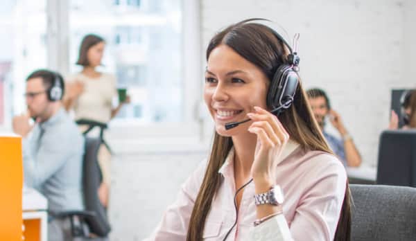 Female receptionist smiling while answering calls